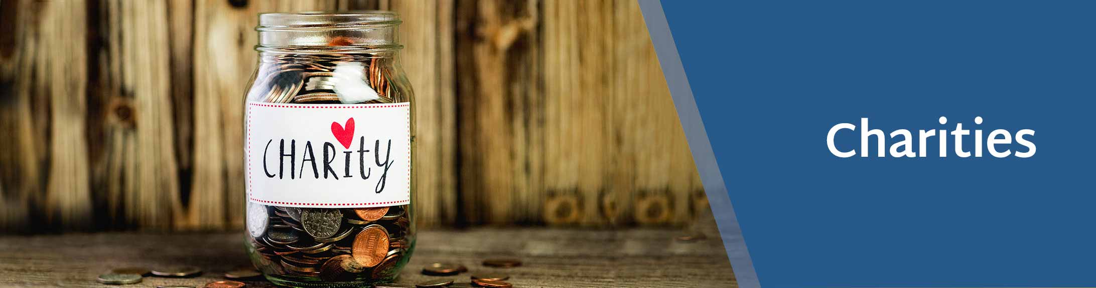 glass jar with coins in with a charities label on it - Charities